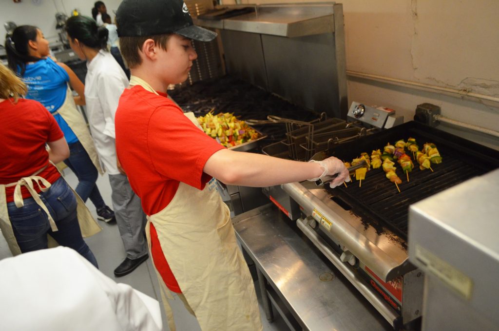 Duncan grilling chicken skewers during Camp Delicious! 2019