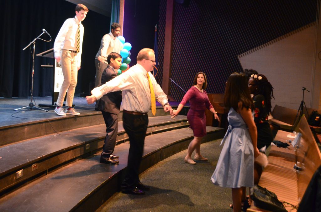 2019 Teen Speakers and directors dancing in the auditorium