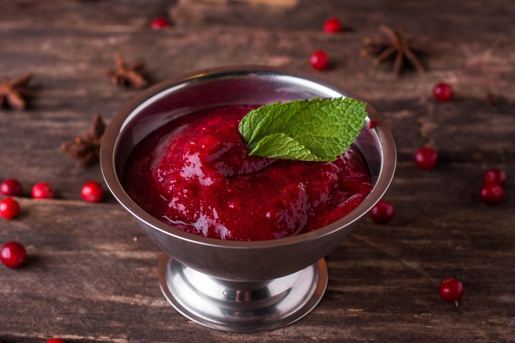 Cranberry relish in a bowl on a wooden table