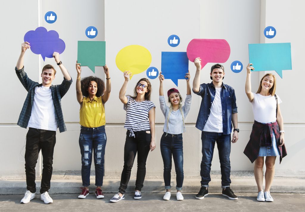 Young adults holding colorful people bubbles