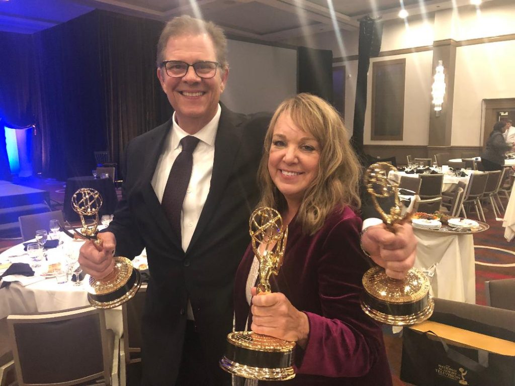 Patrick helping Beth hold all her Emmys. 