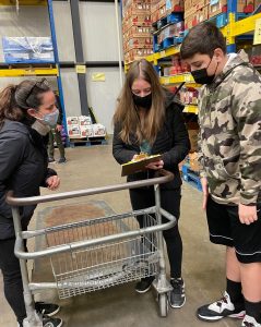 Sofia & John talking through the grocery list with Chef Erika