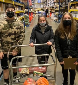 Sofia & John talking through the grocery list with Chef Erika